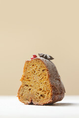 A piece of bundt cake in festive wintery Christmas arrangement.	