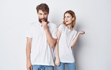 Fototapeta premium cheerful man and woman in headphones listening to music and dancing on gray background cropped view
