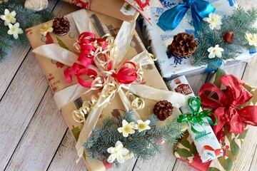 Holiday Christmas presents wrapped with elegant bows and ribbons ready for Santa Clause to deliver on Christmas Eve 