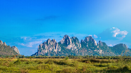The picturesque mountains on a sunny day with a blue sky and mountain as a cape are at Nakhon  Sawan, Thailand
