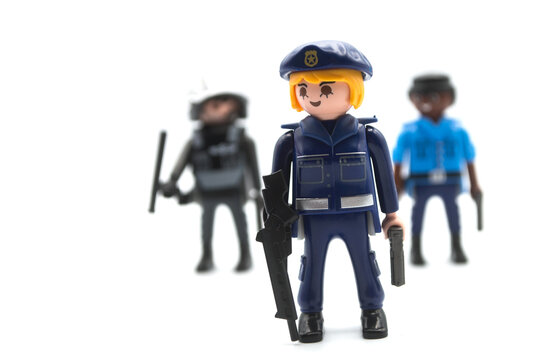 Mulhouse - France - 12 December 2020 - Closeup of playmobil figurines on white background - policemen with uniforms and shotguns