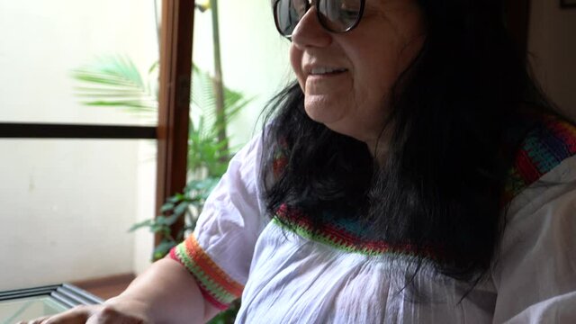 Mujer usando la computadora en su casa.