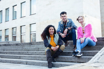 Fototapeta premium cute group of teenages at the building of university with books huggings, diversity nations real students lifestyle