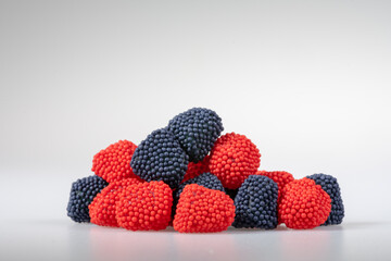 Spread out pile of gummy candies on white