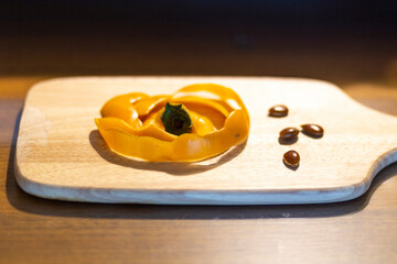 Persimmon skin and water on the serving board, top view
