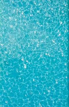 Aerial view of a large crystal blue pool. A lot of negative space is in the image