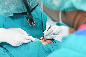 Doctor and assistant to perform nose surgery