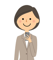 スマホを触るするスーツの女性
