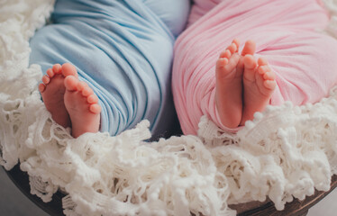 Fototapeta na wymiar Foots of newborn twins boy and girl