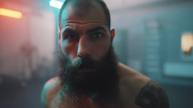 Boxer in the boxing gym. Bandages his hands. Sparring in the ring. Boxer jumping rope. Exercise with ropes. Round one. Fog in the ring. Zetsky sport. Beautiful backlight. World boxing champion.

