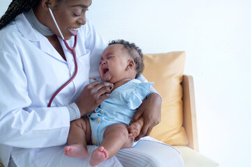 African doctor checking mix race newborn baby, Pediatrician examining baby girl with stethoscope