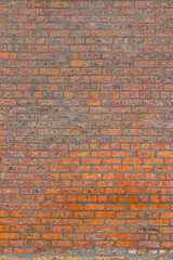 Naklejka premium Full frame shabby chic vintage brick wall texture background, with fiery hot looking bricks in burnt shades of orange, red and brown