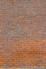 Full frame shabby chic vintage brick wall texture background, with fiery hot looking bricks in burnt shades of orange, red and brown