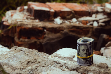 American dollar on fragments of old red and white bricks, close-up.