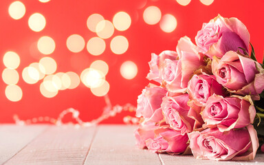 Valentine's day background. Bouquet of roses on a red background. Copy space.
