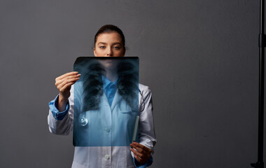 doctor in medical gown with x-ray on gray background research in laboratory