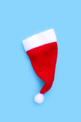 Obraz na płótnie Canvas Santa hat on blue background.