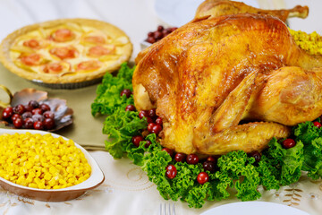 Christmas dinner with apple pie. Roasted turkey garnished cranberries and kale.