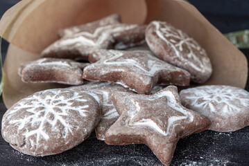 Homemade round and star shaped christmas gingerbreads in a paper bag