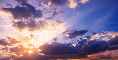 Naklejka na ściany i meble sunset sky, sunlight shining through clouds in the evening