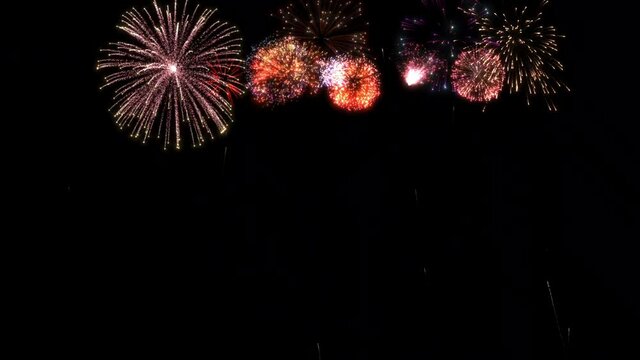 2021 greeting text with colorful fireworks and sparks on black night sky. New year animation.