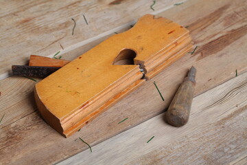 carpenter's tools lie on a wooden table clamp plane