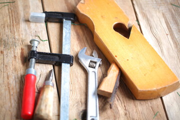 carpenter's tools lie on a wooden table clamp plane