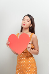 Woman holding big red heart on white background