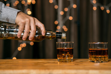 Barman pouring whiskey whiskey glass