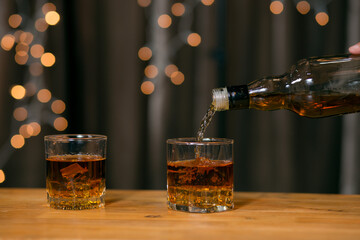 Barman pouring whiskey whiskey glass