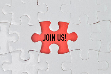 Top view of jigsaw puzzle with word JOIN US. Business and education concept. 