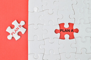 Plan A, Plan B on jigsaw puzzle background, business concept.