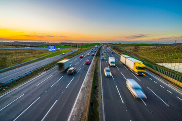 Colorful sunset at M1 motorway near Flitwick junction with blurry cars in United Kingdom