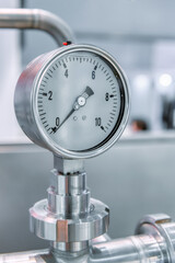 Pressure gauges mounted on the pipeline.