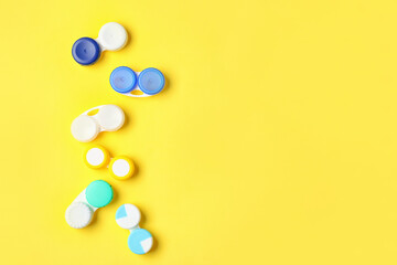 Containers with contact lenses on color background