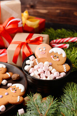 Christmas composition with gingerbread cookies and gifts on table