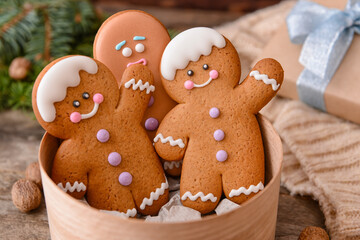 Box with tasty gingerbread cookies on table