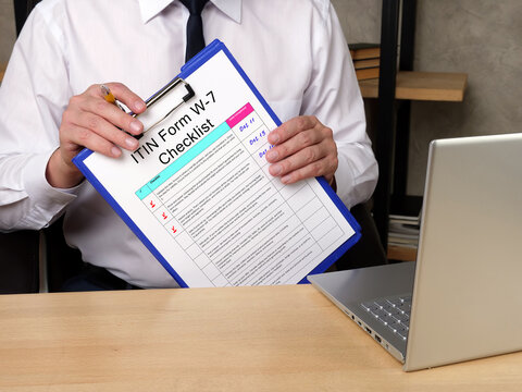  Financial concept meaning Individual Taxpayer Identification Number ITIN Form W-7 Checklist with phrase on the sheet.