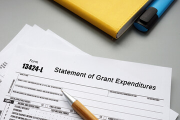 Business concept meaning Form 13424-L Statement of Grant Expenditures with sign on the page.
