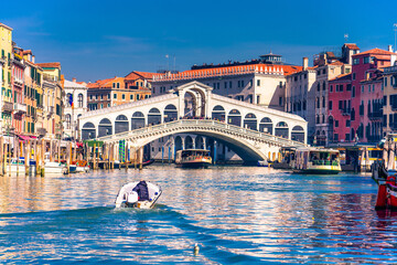 Tourist on the motor boat heading towards Rialto Bridge in Venice. Holiday concept 