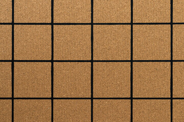 Full frame of natural cork texture with a black lines grid. Cork placemat with empty squares. Schedule board. Reminder message board
