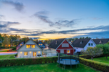 View of traditional Scandinavian timber houses in autumn season at sunset