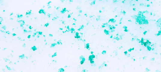 Green paint on the snow in winter.