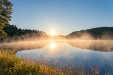 Foggy lake at sunrise in autumn. Swedish landscape