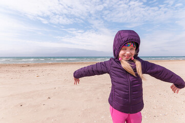 Girl on the beach cold and wind