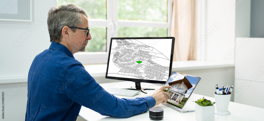 Poster cadastral survey map on office computer