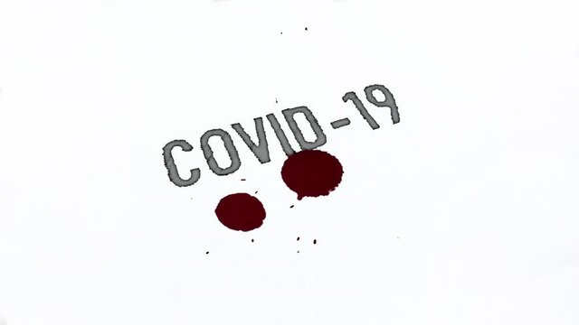 Drops of blood drip onto a sheet of white paper labeled "Covid-19". Red drops and splashes of blood fill the inscription covid-19 coronavirus on a white background. This year's pandemic.