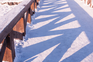wooden bridge across the river in the Park shadow on snow pattern abstract winter 2016