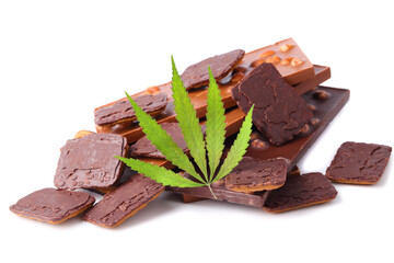 Bars of black and milk chocolate with cookies containing CBD cannabis and green hemp leaf on white isolated background. Chocolate with marijuana extract. Entertainment drug concept