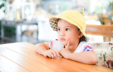 Little asian child girl, Cute girl children kids playing dining table.